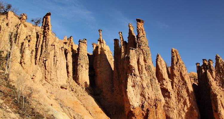 Unique natural rock formations under a clear blue sky.