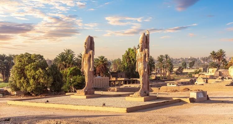 Two statues in a desert setting at an Egyptian archaeological site