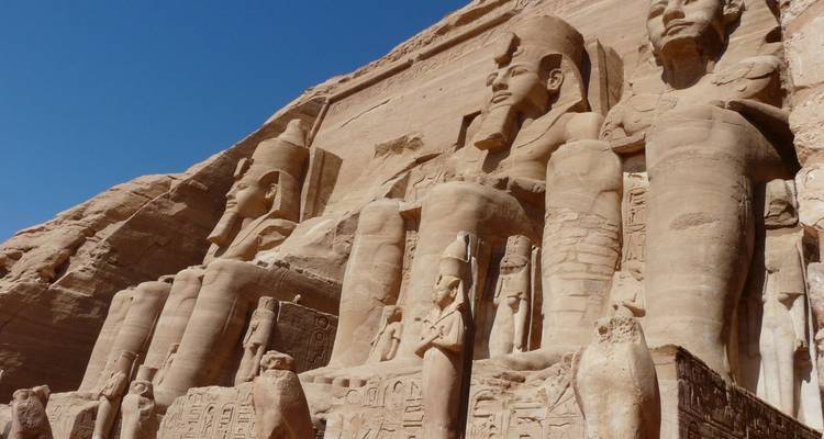 Colossal statues of Pharaoh Ramses II carved into the sandstone façade of Abu Simbel.