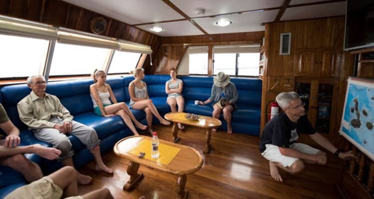 People relaxing in a lounge area on a boat.