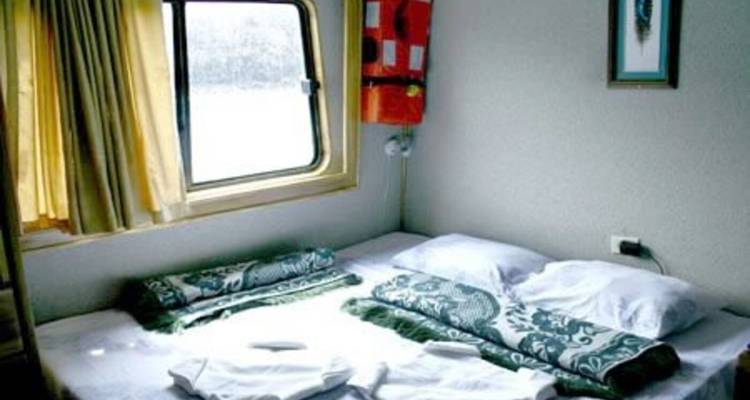 Boat cabin interior with a window view.