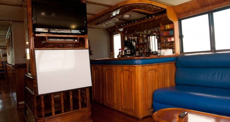 Boat bar area with seating and a TV.