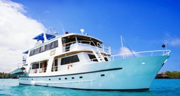 Luxury yacht anchored in turquoise waters.
