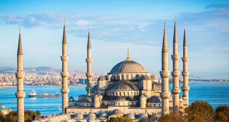 Blue Mosque with multiple minarets overlooking the sea.