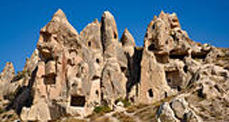 Rock formations with small windows and doorways.
