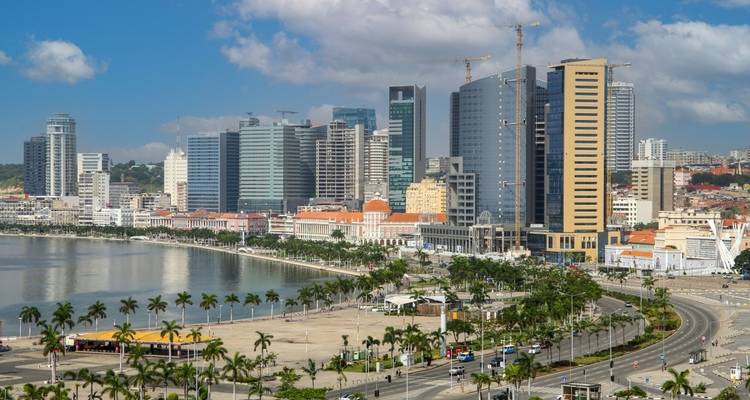 A cityscape view of modern high-rise buildings by the beach.