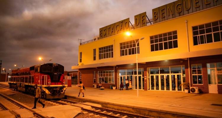 A train station with a locomotive in the early evening.
