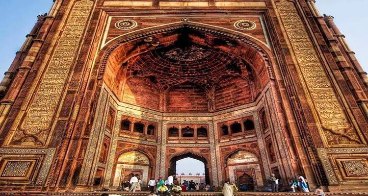 Imposing gate structure with intricate designs and people entering