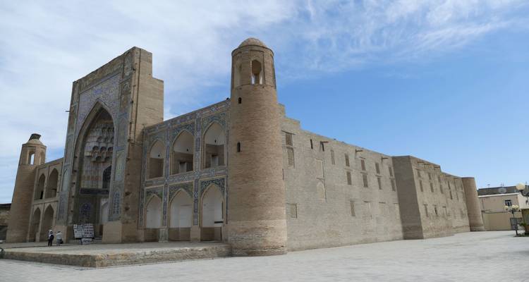 A large, historic building with blue and tan stone exteriors.