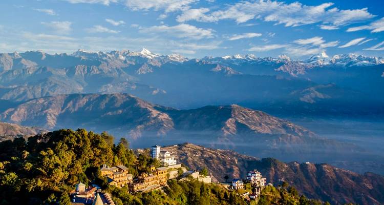 Mountainous landscape with trees and buildings.
