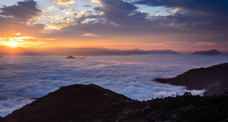 Clouds over a mountain range during sunset.