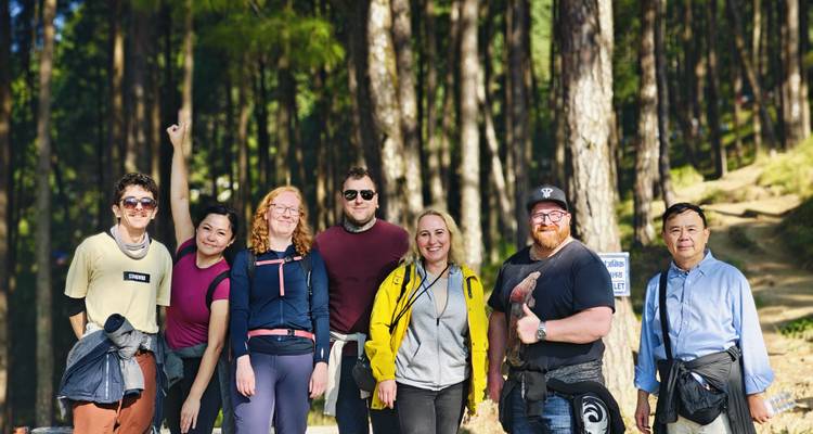 A small group of hikers posing in a forest.