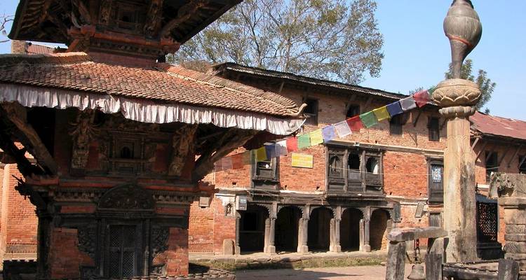 Traditional Nepalese architecture with prayer flags and intricate brickwork.