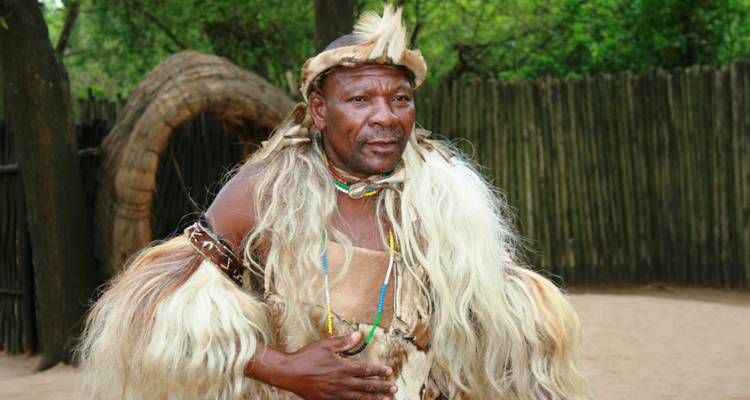 Person in traditional attire in a cultural setting.
