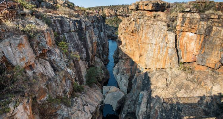 Deep rocky gorge with a river running through it.