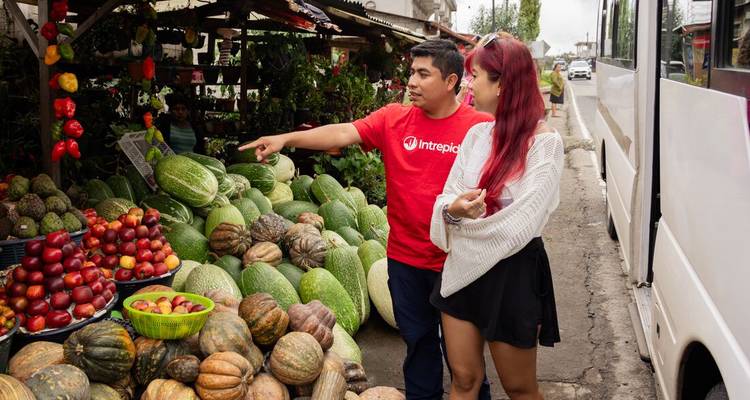 Two people browsing fresh produce at a market.