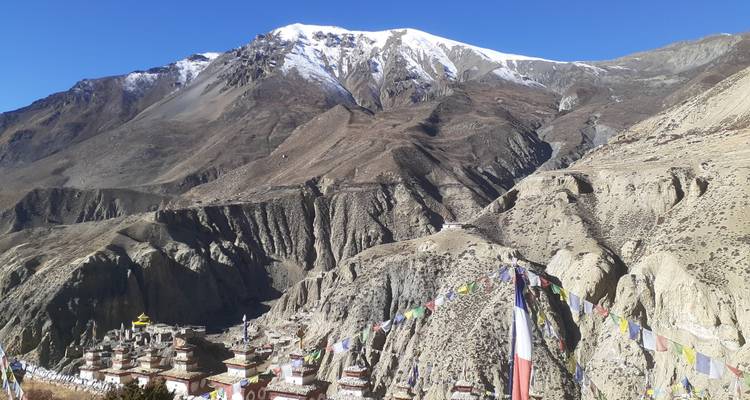 Monastery and prayer flags in a mountainous region.