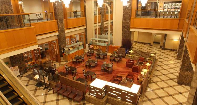 Hotellobby mit Sitzgelegenheiten und Marmordekoration.