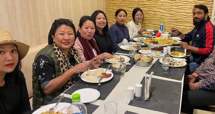 Group gathered around a table enjoying a meal.