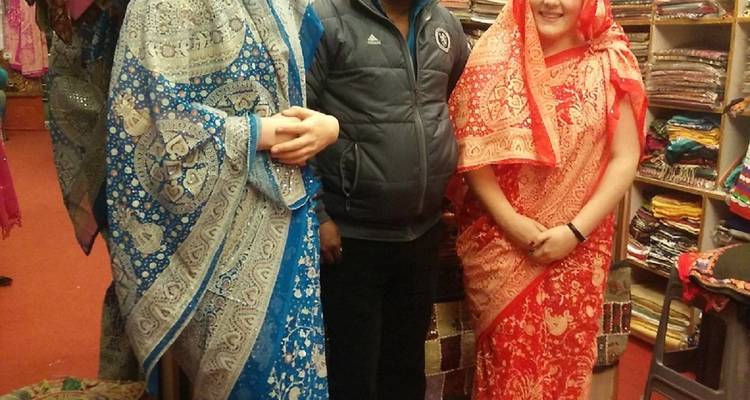 People in traditional garments inside a shop.