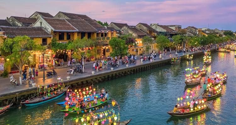Colorful boats with lanterns in a canal in the evening.