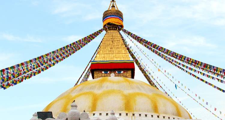 Boudhanath Stupa during the day with colorful prayer flags.