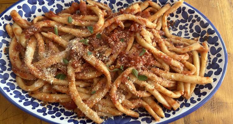 Plate of pasta with sauce on a decorative dish