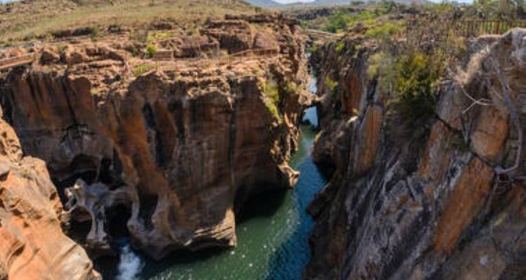 Landscape with rocky gorge and river below.