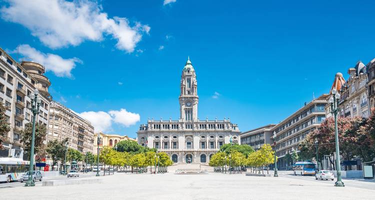 City square with a historic building and clear blue skies.