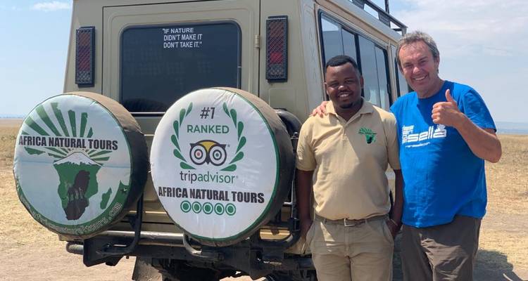 Two men near a safari vehicle.