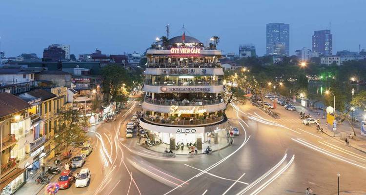 Circular City View Cafe building in Hanoi with traffic.