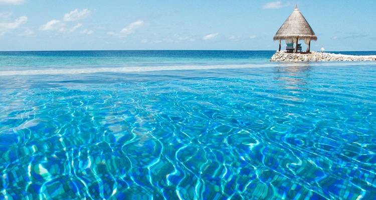 Turquoise water with a small pavilion on the horizon.
