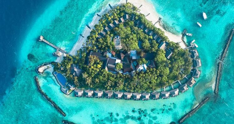 Aerial view of resort island surrounded by turquoise water.