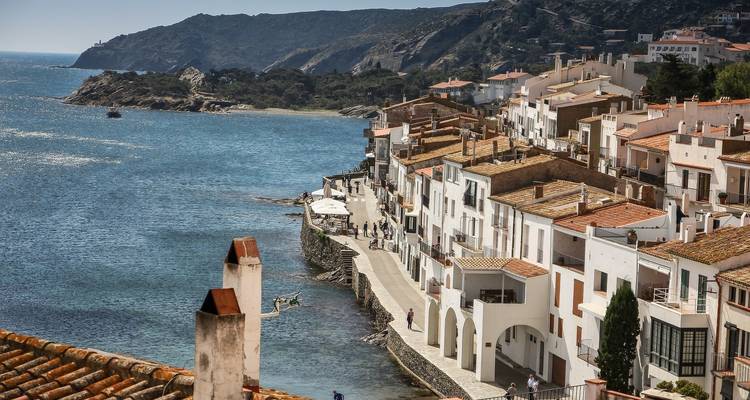 Coastal town with white buildings by the sea.