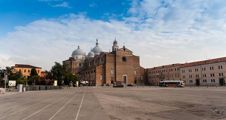 Historic cathedral with multiple domes and a brick plaza.
