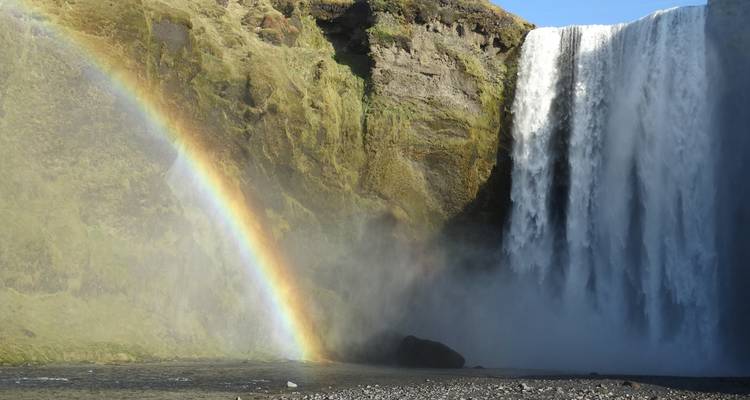 Waterfall with a rainbow in a dramatic landscape