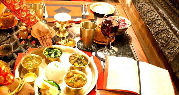 A spread of traditional Nepali dishes on a decorative table.