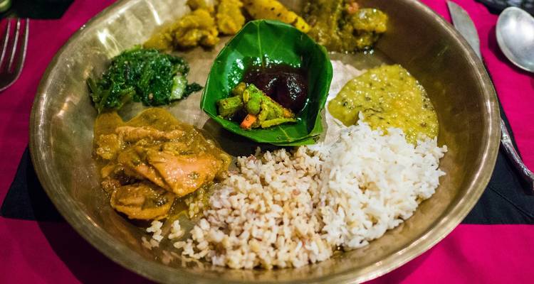 A plate filled with various Nepali dishes.