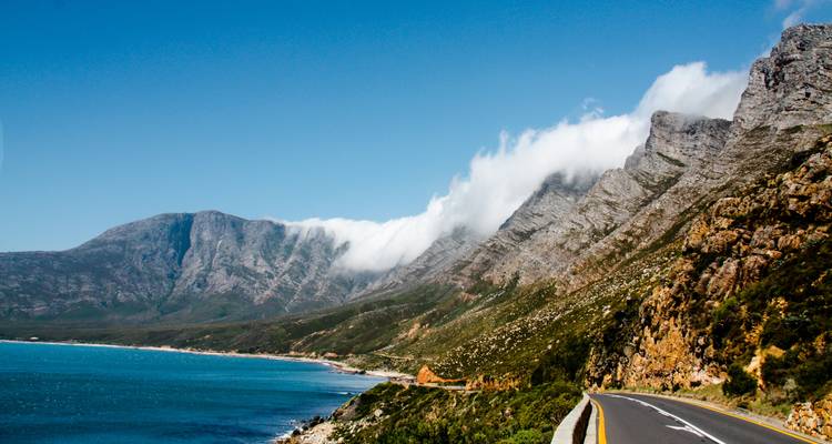 Malerische Küstenstraße mit Bergen und Ozean.