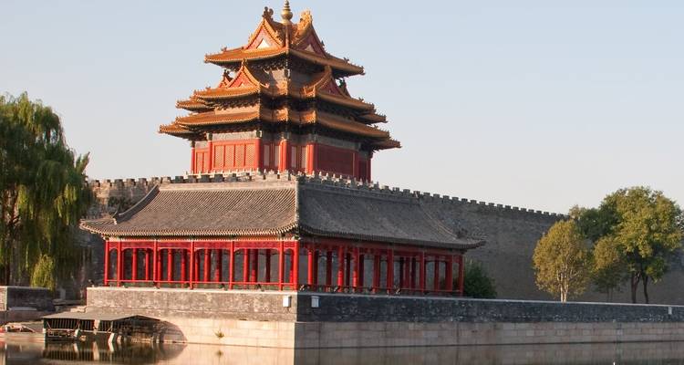 Traditional Chinese building with intricate design and water reflection.
