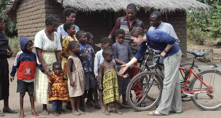 Group of people interacting with local villagers.