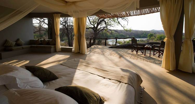 Luxury open accommodation with a view of wilderness.