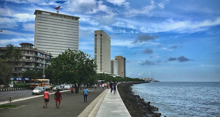 Seaside promenade with high-rise buildings.