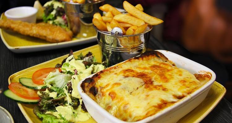 Italian dish with salad and fries in a restaurant