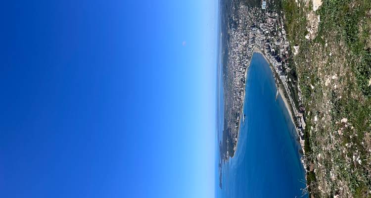 Coastal view with beach and buildings stretching along the coastline.
