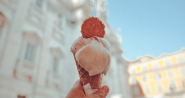 Gelato held up against a sunny backdrop