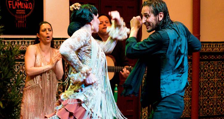 A flamenco performance with dancers on stage.