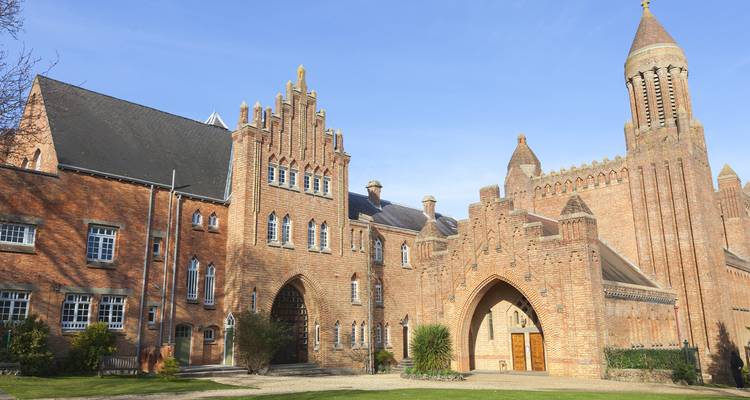 Historic brick building with ornate towers and Gothic arches.