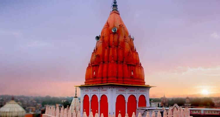 Tempel mit rotem Turm bei Sonnenuntergang in Varanasi.