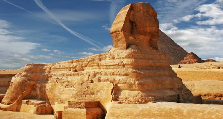 The Great Sphinx and a pyramid in the background.